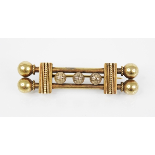 121 - A Victorian Etruscan style gold coloured brooch, designed as two tubular bars with three rope twist ... 