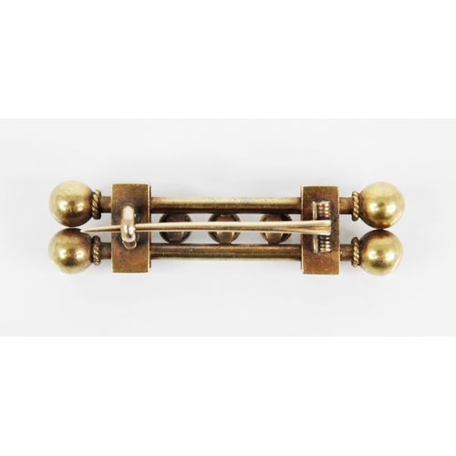 121 - A Victorian Etruscan style gold coloured brooch, designed as two tubular bars with three rope twist ... 