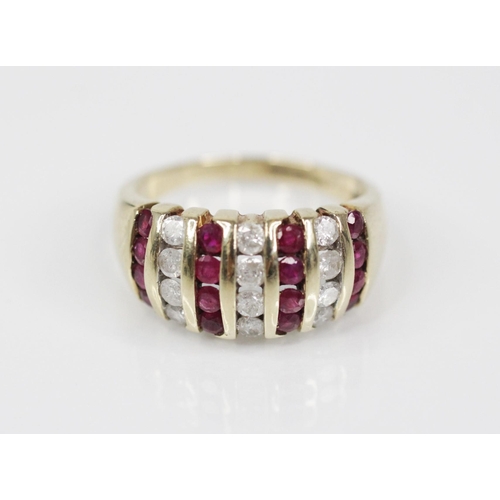 124 - A ruby and diamond 9ct gold bombe ring, the head designed as alternating rows of brilliant cut diamo... 