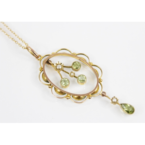 129 - An Edwardian peridot and pearl 9ct pendant, the principal three branch drop set with round mixed cut... 