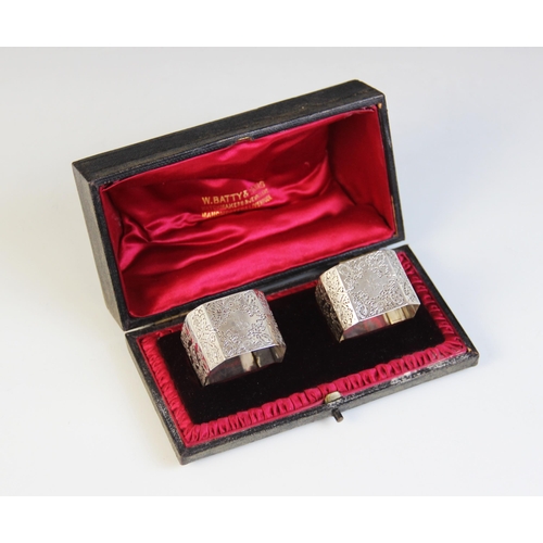 47 - A pair of Victorian silver napkin rings, Atkin Brothers, Sheffield 1897, each of square form with ca... 