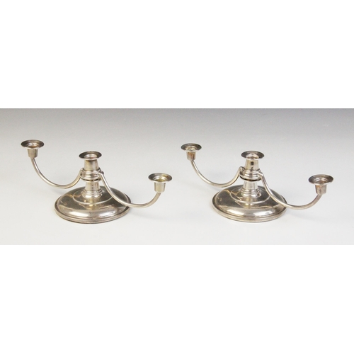 48 - A pair of silver three branch miniature candelabras, Bishton's Ltd, Birmingham 1972, each on circula... 