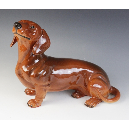 566 - A Beswick fireside dachshund, model No. 2286, in tan colourway, 17cm high