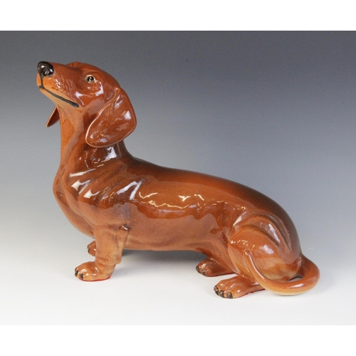 566 - A Beswick fireside dachshund, model No. 2286, in tan colourway, 17cm high