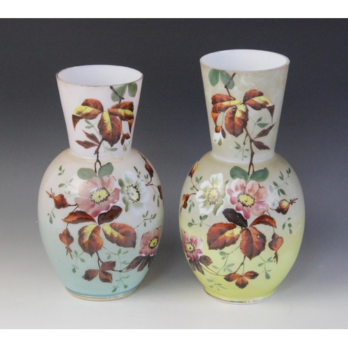 583 - A near pair of Victorian painted opaline glass vases, each of ovoid form with tapered necks, decorat... 