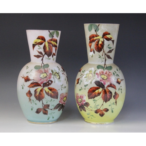 583 - A near pair of Victorian painted opaline glass vases, each of ovoid form with tapered necks, decorat... 