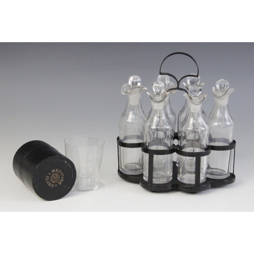 590 - A six bottle cruet set, each clear glass double lipped bottle with associated stopper, and engraved ... 