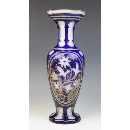 593 - A Victorian bohemian blue glass vase, of inverted baluster form with trumpet neck on circular foot, ... 