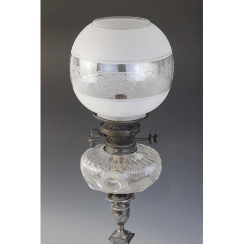 601 - An Edwardian Adams influence silver plated oil lamp, the associated etched glass shade above a cut g... 