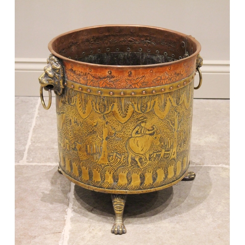 613 - An early 20th century copper and brass cylindrical log bin, embossed with figures in a rural landsca... 