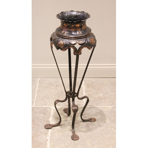 614 - An Art Nouveau Jugendstil type copper jardiniere and stand, early 20th century, the jardinere elabor... 