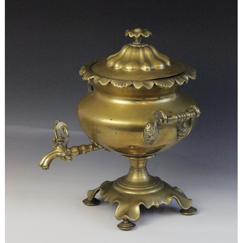 619 - A 19th century brass samovar, of compressed circular form with shaped rim and twin scrolling handles... 