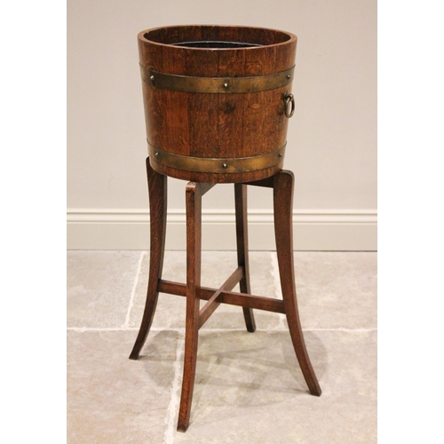 629 - A brass bound coopered oak jardinière on stand, early 20th century, the circular tub applied with ri... 