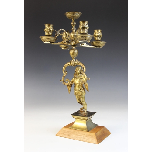 640 - A Victorian figural brass oil lamp, later converted, the associated amber glass and etched shade abo... 