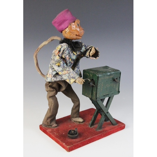 641 - A scratch built clockwork automaton modelled as a monkey winding an organ, the Papier Mache head wit... 