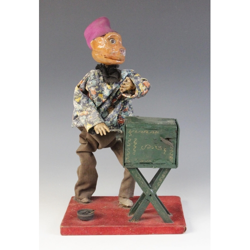 641 - A scratch built clockwork automaton modelled as a monkey winding an organ, the Papier Mache head wit... 