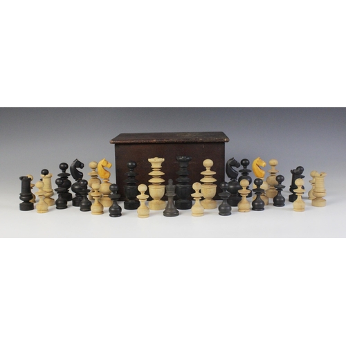 668 - A turned a carved boxwood and ebonised chess set in the French Regence pattern, the kings 9.8cm high... 