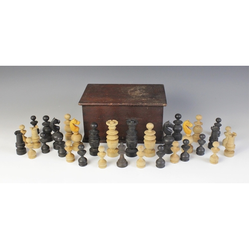 668 - A turned a carved boxwood and ebonised chess set in the French Regence pattern, the kings 9.8cm high... 