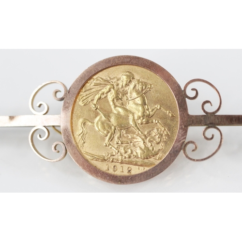 68 - A George V sovereign, dated 1912, set to a yellow metal bar brooch with scrolling surround, hinged p... 