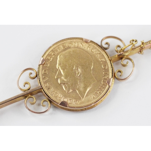 68 - A George V sovereign, dated 1912, set to a yellow metal bar brooch with scrolling surround, hinged p... 