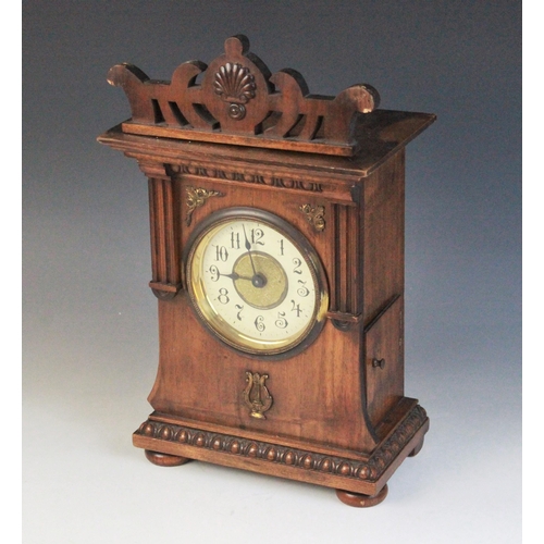 688 - A late 19th/early 20th walnut cased German musical bracket clock, the openwork pediment above an arc... 