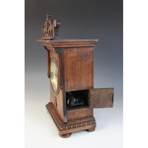 688 - A late 19th/early 20th walnut cased German musical bracket clock, the openwork pediment above an arc... 