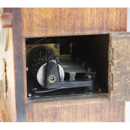 688 - A late 19th/early 20th walnut cased German musical bracket clock, the openwork pediment above an arc... 