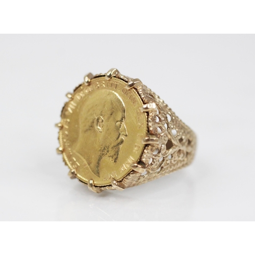 69 - An Edwardian half sovereign, dated 1905, set to a 9ct gold ring mount, with pierced scrolling should... 