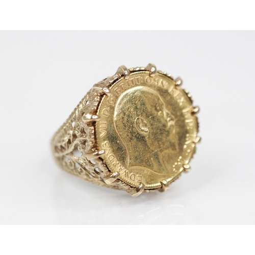 69 - An Edwardian half sovereign, dated 1905, set to a 9ct gold ring mount, with pierced scrolling should... 