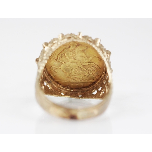 69 - An Edwardian half sovereign, dated 1905, set to a 9ct gold ring mount, with pierced scrolling should... 