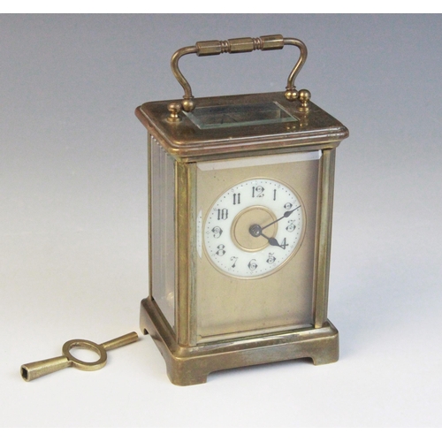 690 - An early 20th century brass cased carriage timepiece, the 5cm ivory coloured ceramic dial applied wi... 