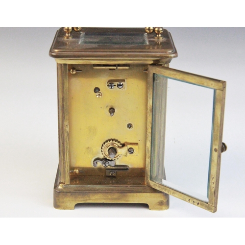 690 - An early 20th century brass cased carriage timepiece, the 5cm ivory coloured ceramic dial applied wi... 