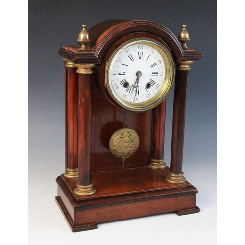 691 - A late 19th century French mahogany and gilt metal mounted portico clock, the arched pediment flanke... 