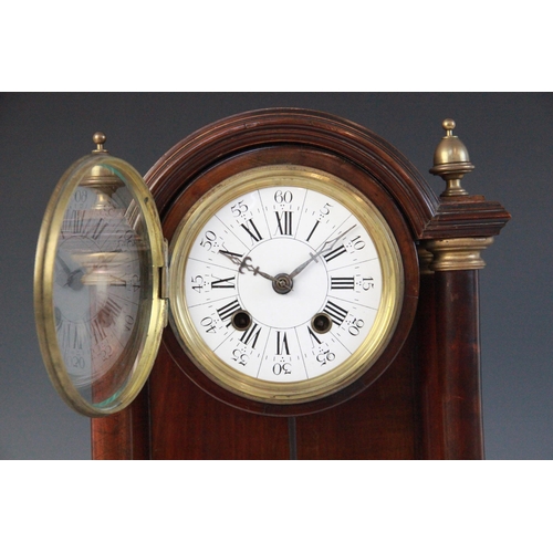 691 - A late 19th century French mahogany and gilt metal mounted portico clock, the arched pediment flanke... 