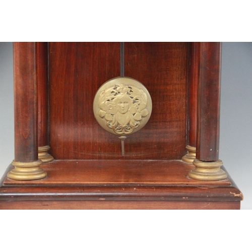 691 - A late 19th century French mahogany and gilt metal mounted portico clock, the arched pediment flanke... 