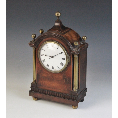 694 - A Regency style mahogany cased mantel timepiece, early 20th century, the arched case with spherical ... 