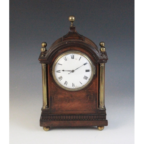 694 - A Regency style mahogany cased mantel timepiece, early 20th century, the arched case with spherical ... 