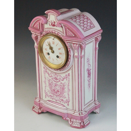 695 - A late 19th century Gien pottery mantel clock, the architectural case highlighted with pink and red ... 