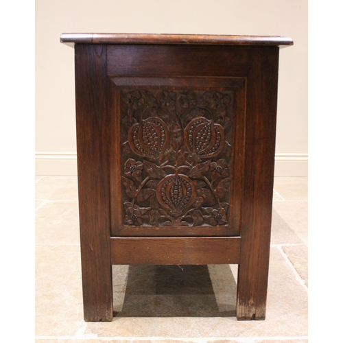 702 - A 17th century style oak coffer, mid 20th century, the three panel hinged top over a central panel c... 