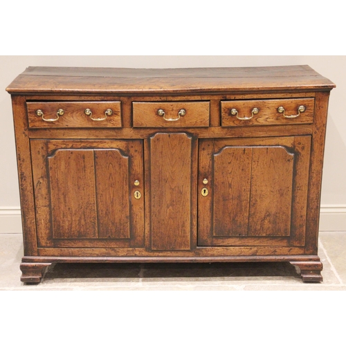 709 - An 18th century oak dresser base, the moulded plank top above three oak lined drawers and a pair of ... 