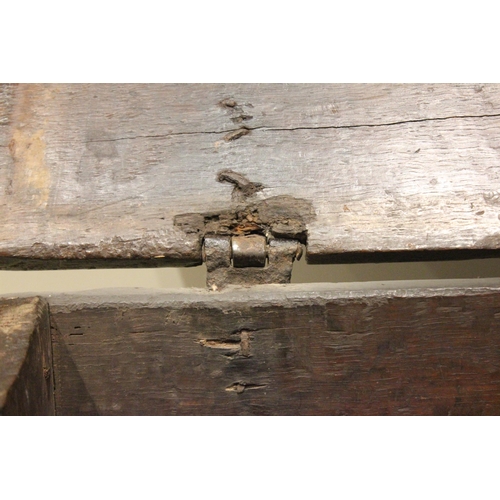 713 - A 17th century oak six plank coffer bach, the channelled and serrated hinged cover applied with an i... 