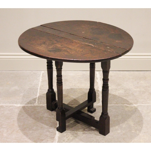 717 - An 18th century and later narrow oak drop leaf occasional table, the circular top raised upon ring t... 