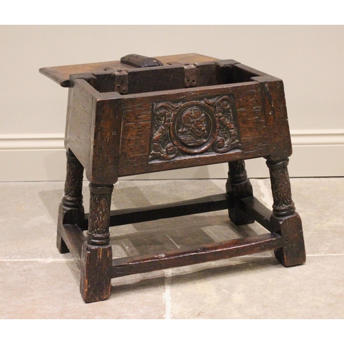 720 - A 17th century and later hinged oak joint stool, the rectangular moulded hinged top above a front pa... 