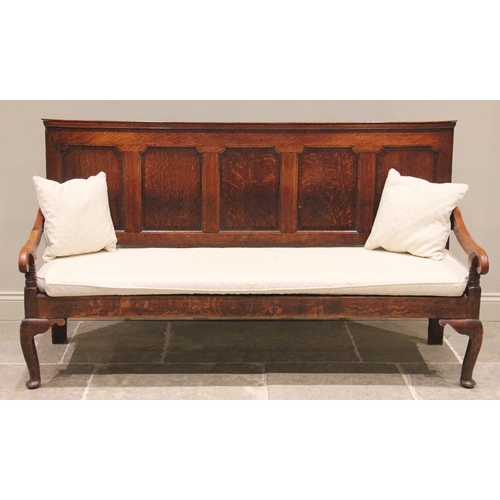 724 - A George III oak five panel settle, the moulded back rail above five invert moulded panels and a lat... 