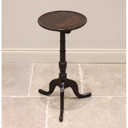 733 - A George III oak tripod table or candle stand, the circular top with a raised moulded rim, upon a ri... 