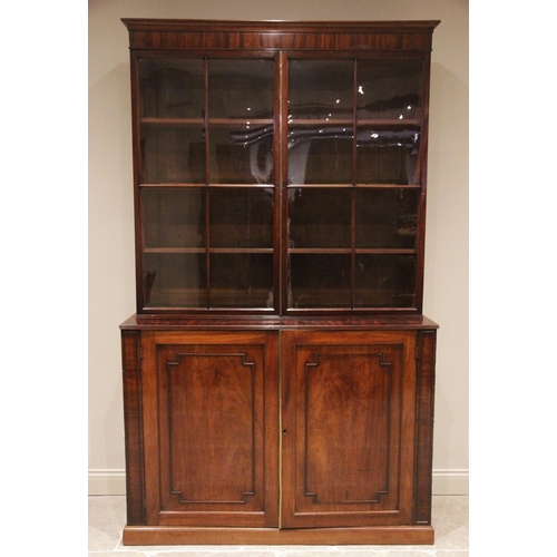 735 - A large Regency mahogany library bookcase, the cavetto cornice above a plain frieze and a pair of qu... 