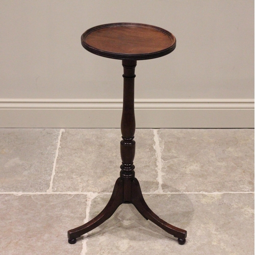 740 - An early 19th century mahogany tripod table or candle stand, the circular top with a raised moulded ... 