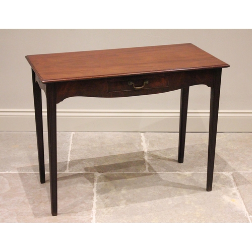 743 - A George III mahogany side table, the rectangular moulded top above a shaped apron and single frieze... 