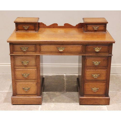 756 - A late Victorian walnut twin pedestal dressing table/desk, the shaped rear gallery flanked by two sm... 