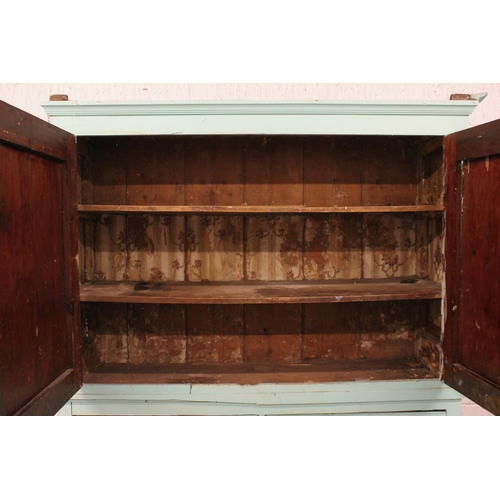 760 - A 19th century painted pine housekeepers cupboard, the moulded cornice above a pair of relief moulde... 